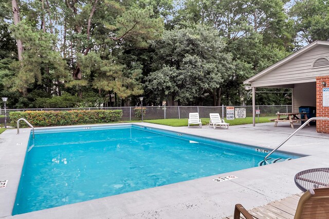 565 Travelers Blvd, Summerville, SC 29485 - community pool featuring a patio and view of wooded area