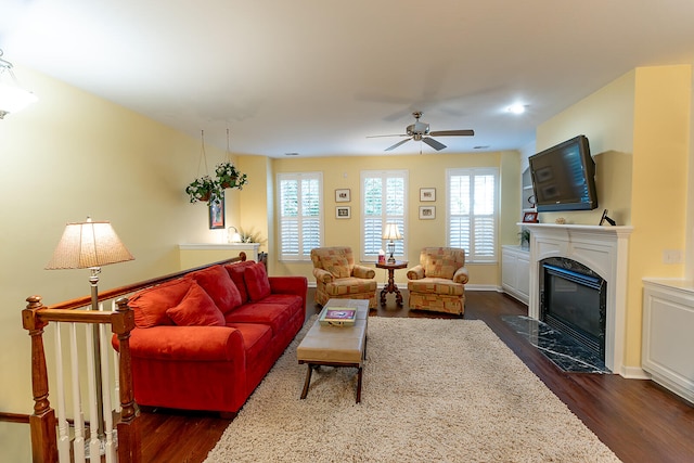 living room featuring dark hardwood / wood-style flooring and ceiling fan