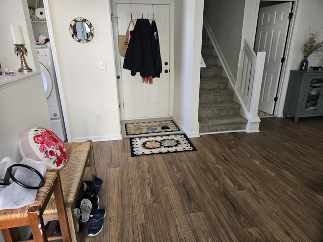 entrance foyer with dark wood finished floors, baseboards, and stairs