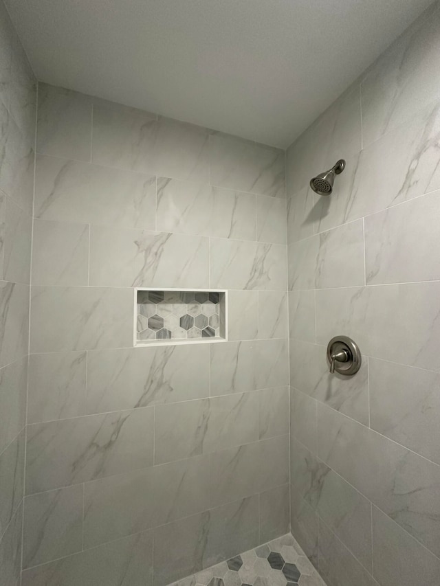 bathroom with a tile shower