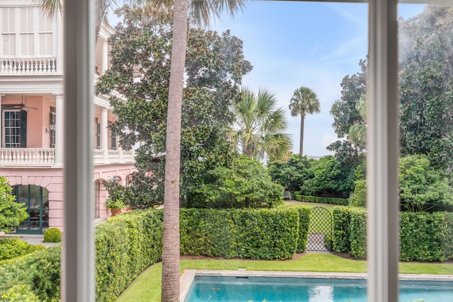 view of swimming pool featuring ceiling fan