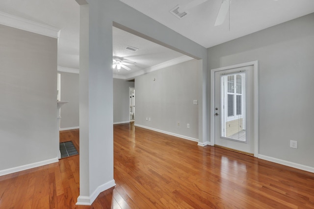 unfurnished room with hardwood / wood-style flooring, crown molding, and ceiling fan