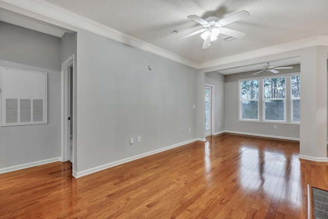 empty room with ceiling fan, crown molding, light hardwood / wood-style floors, and a textured ceiling