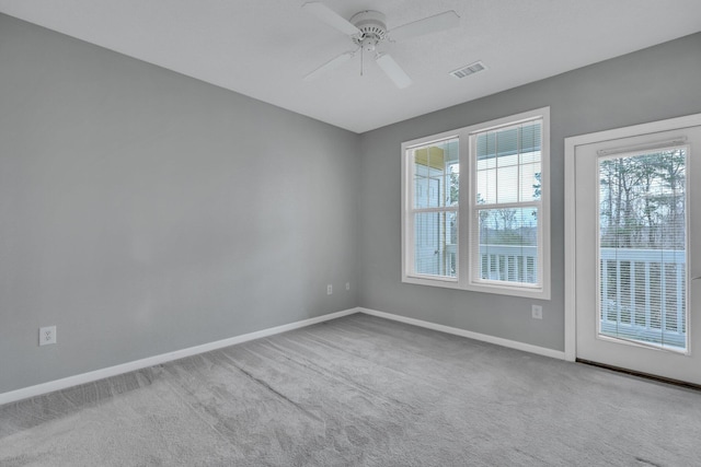 carpeted empty room featuring ceiling fan and a healthy amount of sunlight