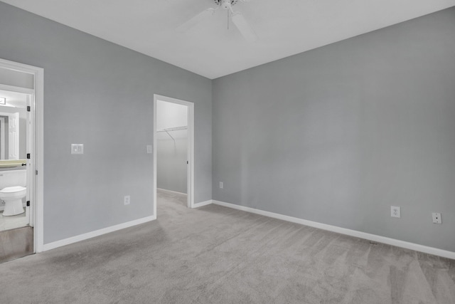 unfurnished room with light colored carpet and ceiling fan