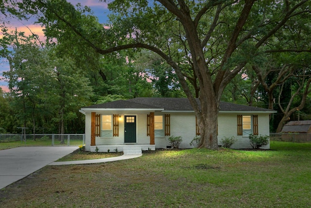 ranch-style home with brick siding, a porch, concrete driveway, and roof with shingles