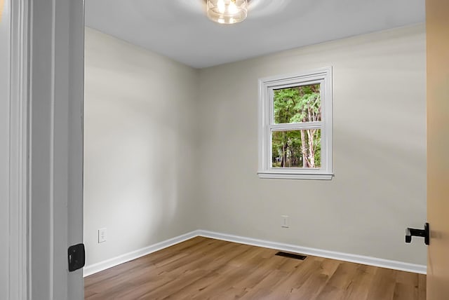 empty room featuring baseboards and wood finished floors