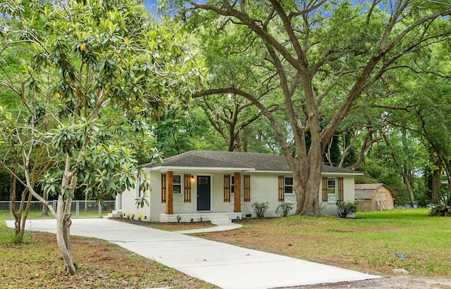 view of front of home with concrete driveway, covered porch, and roof with shingles