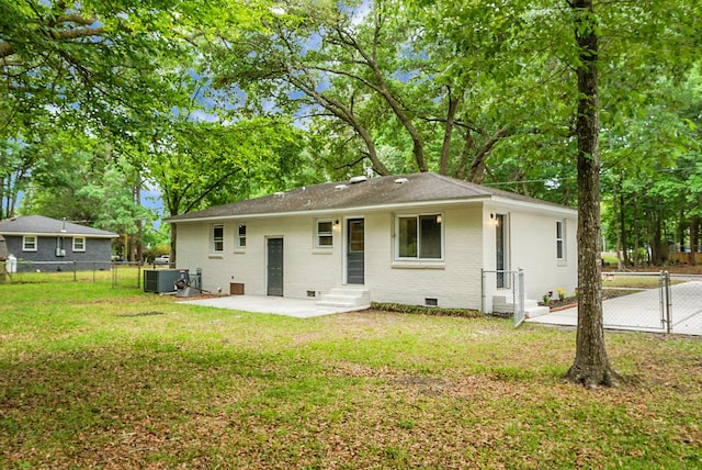 rear view of house featuring a gate, brick siding, a patio area, entry steps, and crawl space