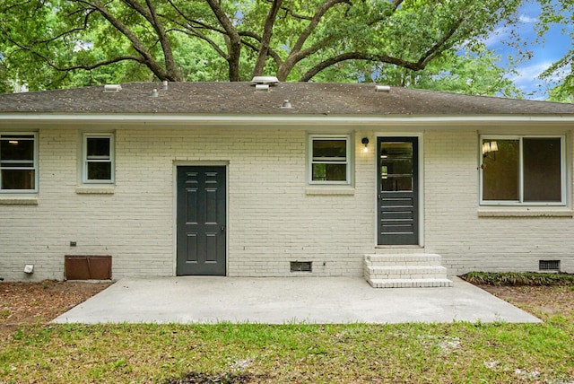 view of front of home featuring crawl space, entry steps, brick siding, and a patio area