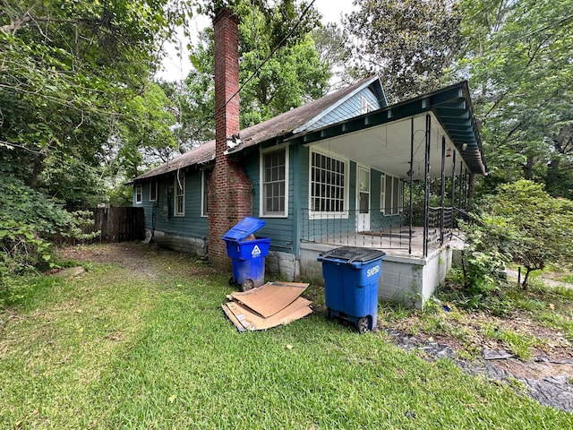 1640 Dogwood Rd, Charleston, SC 29414 - view of home's exterior with a chimney and covered porch