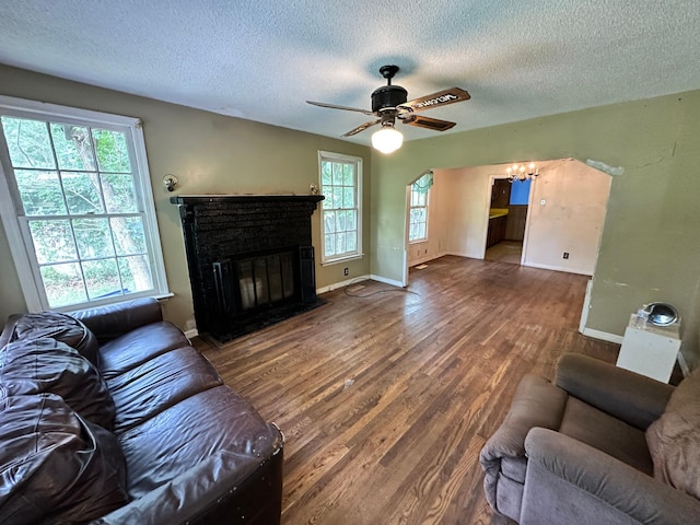 1640 Dogwood Rd, Charleston, SC 29414 - living area with a textured ceiling, a glass covered fireplace, wood finished floors, ceiling fan, and baseboards
