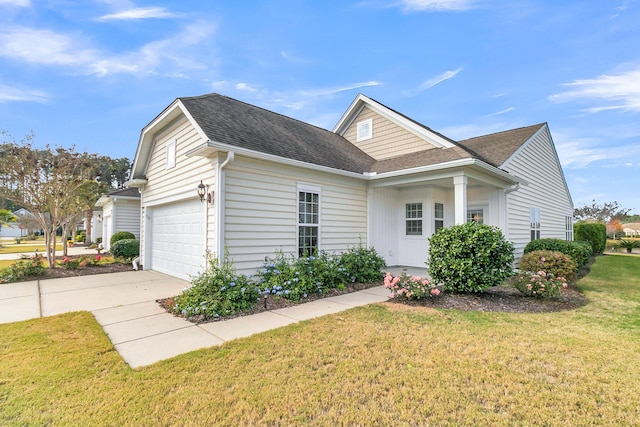 view of front of property featuring a front yard and a garage