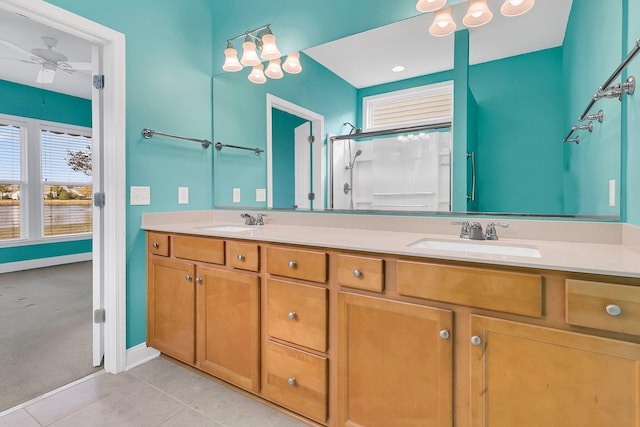 bathroom with ceiling fan, tile patterned flooring, vanity, and a shower with shower door