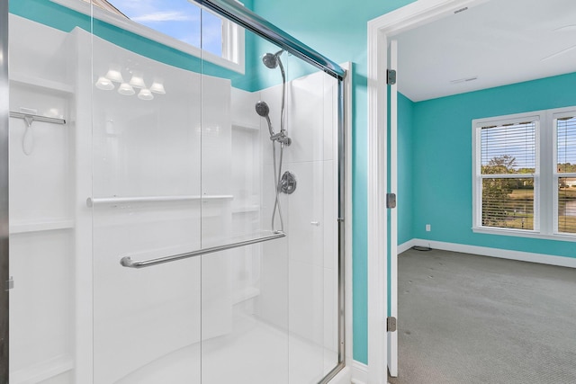 bathroom with a shower with shower door