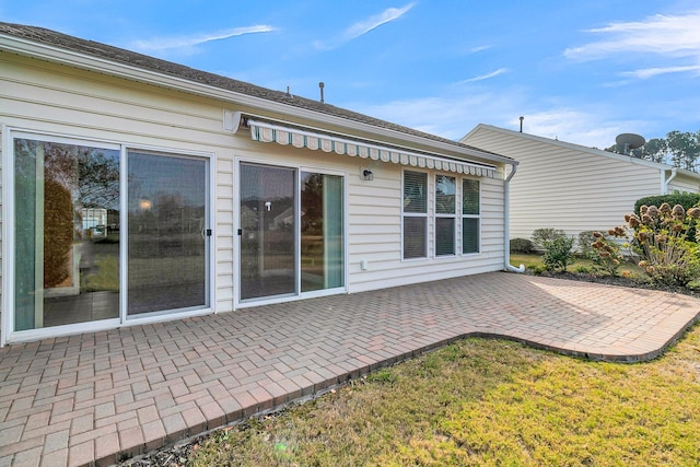 back of property with a patio