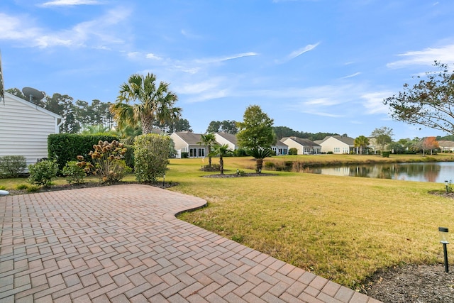 view of yard featuring a patio area and a water view