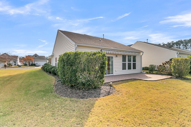 back of property with a lawn and a patio area