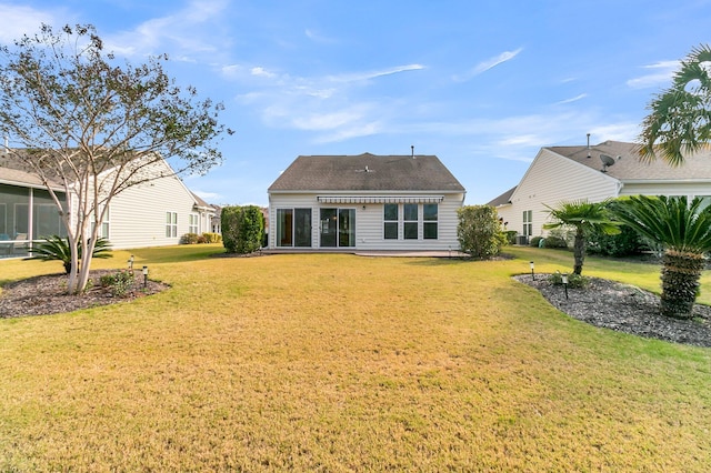 back of house featuring a yard