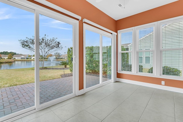 unfurnished sunroom with a water view