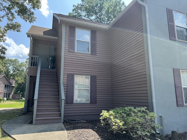 view of side of property with stairway