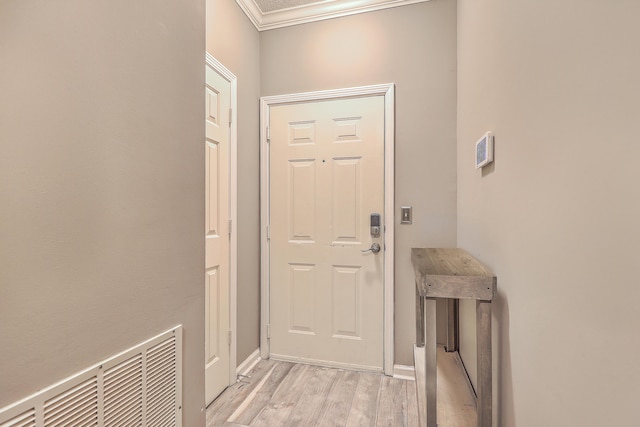 doorway to outside featuring crown molding and light hardwood / wood-style floors