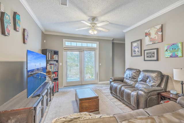 living room with ceiling fan, crown molding, light hardwood / wood-style floors, and a textured ceiling