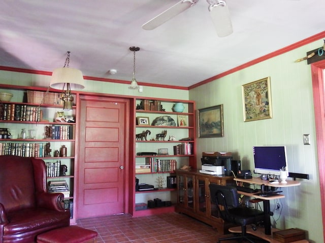 home office featuring built in features, dark tile patterned floors, ornamental molding, and ceiling fan