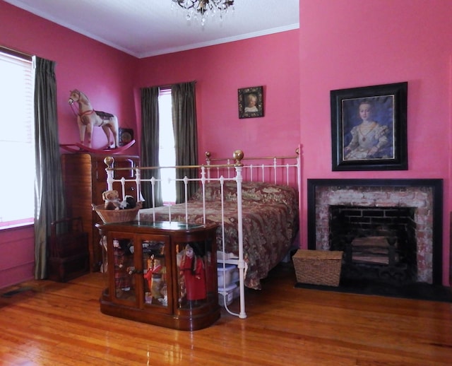 bedroom with crown molding and hardwood / wood-style floors