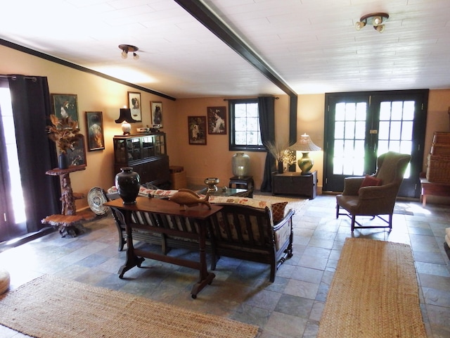 living room featuring a wealth of natural light, french doors, and lofted ceiling