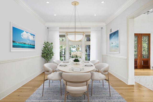 dining area featuring ornamental molding and light wood-type flooring