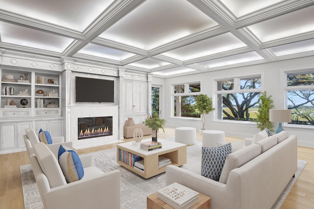 living room featuring coffered ceiling, ornamental molding, a fireplace, beamed ceiling, and light hardwood / wood-style floors