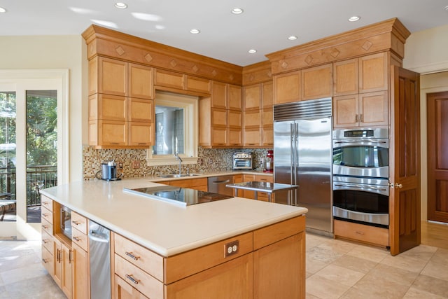 kitchen with built in appliances, sink, kitchen peninsula, and backsplash