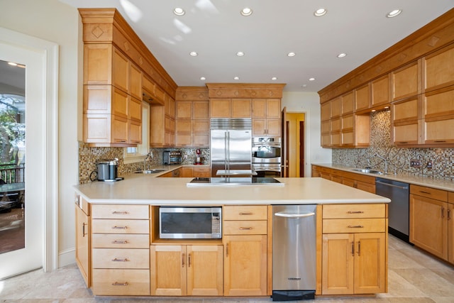 kitchen with sink, stainless steel appliances, and tasteful backsplash