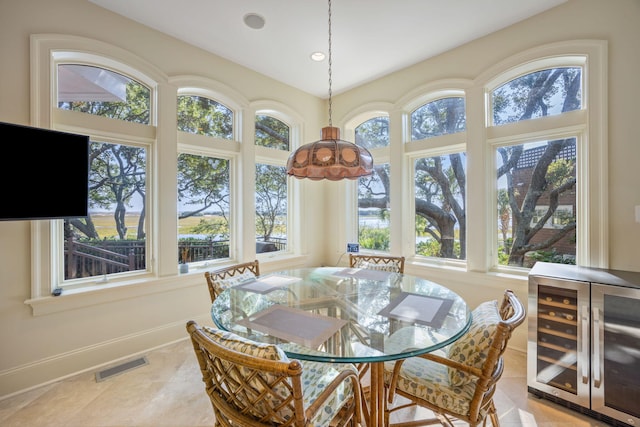 sunroom / solarium featuring beverage cooler