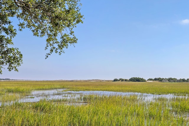 view of landscape with a rural view and a water view