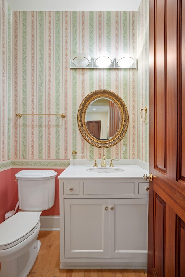 bathroom featuring hardwood / wood-style floors, vanity, and toilet