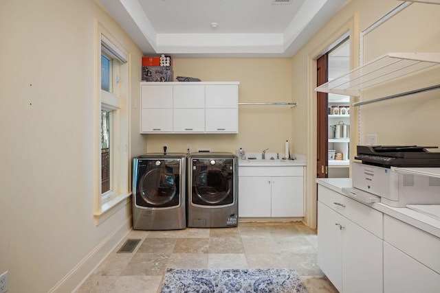 laundry room featuring cabinets, separate washer and dryer, plenty of natural light, and sink