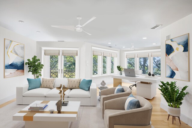 living room with ceiling fan and light hardwood / wood-style floors