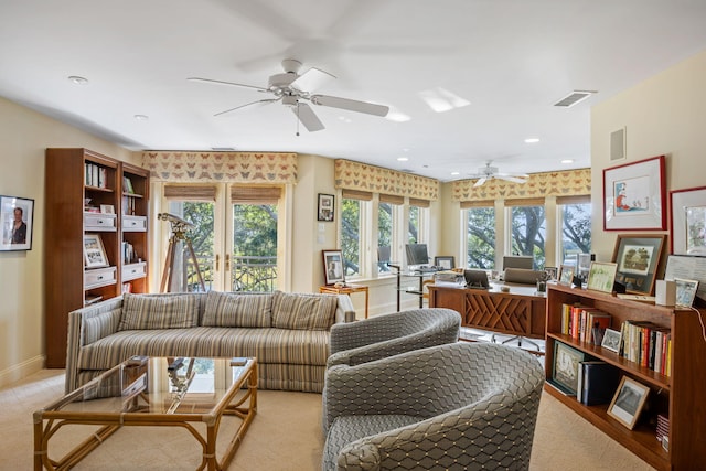 carpeted living room featuring ceiling fan