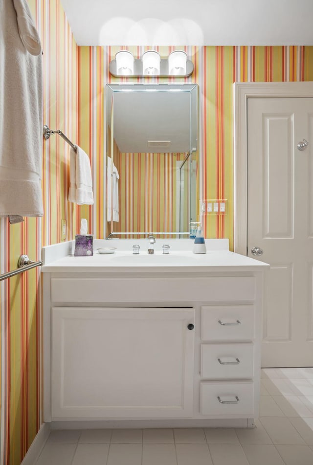 bathroom featuring tile patterned flooring and vanity