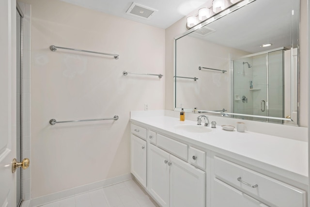 bathroom with vanity, tile patterned floors, and an enclosed shower