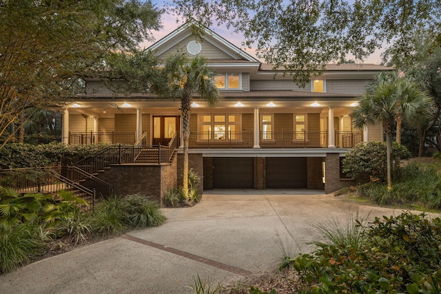 view of front of house featuring a porch and a garage