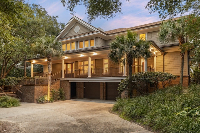 view of front of property with a porch and a garage