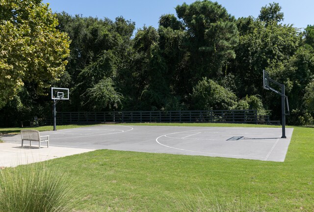 view of basketball court featuring a yard