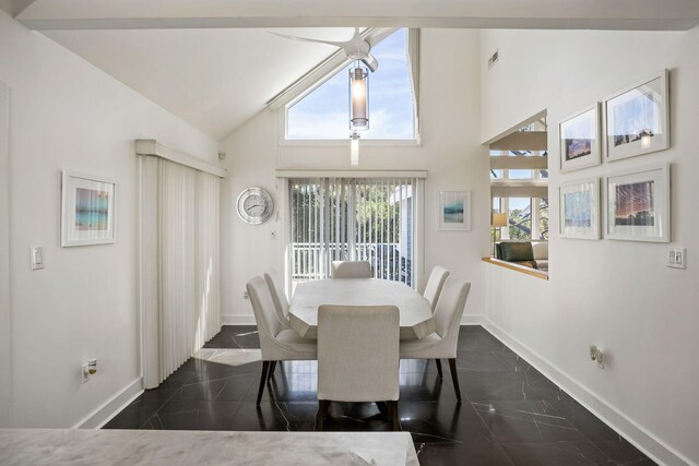 dining room with high vaulted ceiling