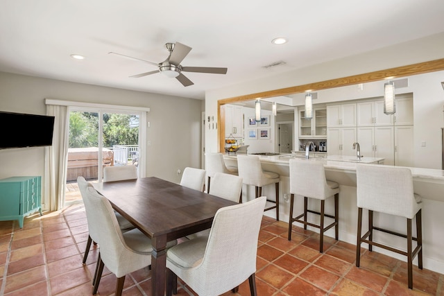 dining room with ceiling fan and sink