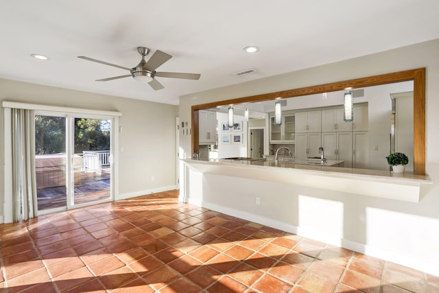 kitchen with tile patterned floors, sink, decorative light fixtures, and ceiling fan