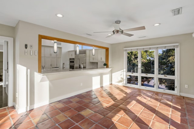 unfurnished living room featuring ceiling fan