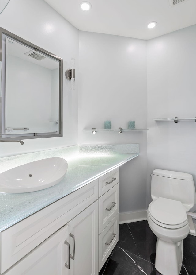 bathroom with toilet and vanity